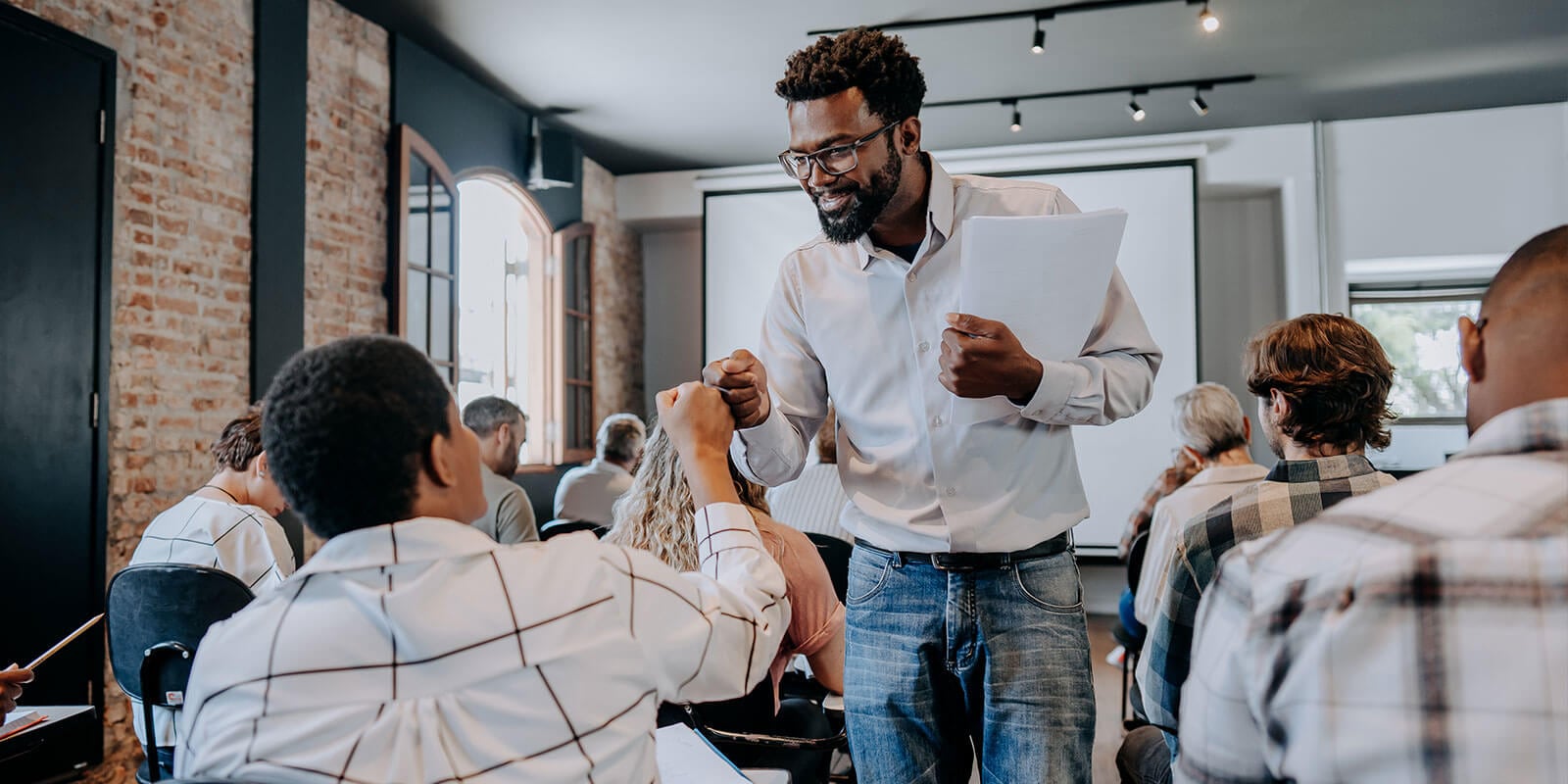 Teacher fist bumping student