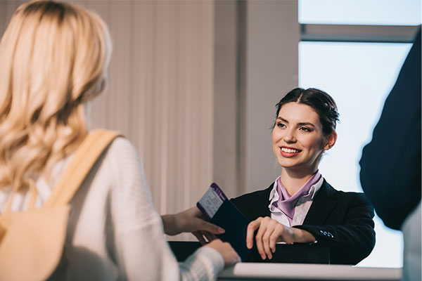 A woman working at a desk talking to a customer
